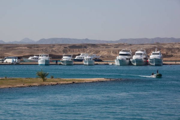 Anchored yachts against desert landscape, Marsa Alam, Egypt